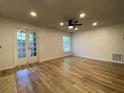 Bright living room featuring wood floors, a ceiling fan, and access to the backyard at 3060 Parc Lorraine, Lithonia, GA 30038