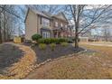 Beautiful home with a brick and siding exterior, complemented by lush landscaping and a stone-lined flowerbed at 2295 Hemrick Rd, Cumming, GA 30041