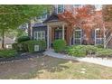 Beautiful brick and siding home with a manicured lawn and walkway leading to the front entrance at 2295 Hemrick Rd, Cumming, GA 30041