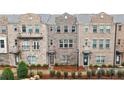 Beautiful three-story brick townhomes featuring elegant facades and manicured landscaping at 3152 Quinn Pl, Atlanta, GA 30341