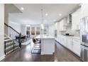 Modern kitchen featuring white cabinets, stainless steel appliances, and an open layout at 3152 Quinn Pl, Atlanta, GA 30341