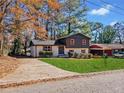 View of a two-story home with a well-manicured lawn and a driveway, set in a neighborhood with mature trees at 2814 Lloyd Rd, Decatur, GA 30034