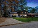 View of a two-story home with a well-manicured lawn and a driveway during twilight hours at 2814 Lloyd Rd, Decatur, GA 30034