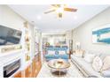 Open-concept living room featuring a fireplace, hardwood floors, and an adjacent kitchen at 3068 Cedar Glade Ln, Buford, GA 30519