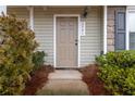 Front door and walkway with manicured shrubs, house number, and neutral colored exterior siding at 3541 Parc Sw Cir, Atlanta, GA 30311