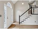 Bright entryway featuring a white door and staircase with black and white banister at 4710 Vineyard Se Ct, Smyrna, GA 30082