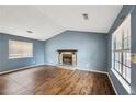 Open living room featuring a fireplace, vaulted ceilings, and plenty of natural light at 1057 Forest Path, Stone Mountain, GA 30088