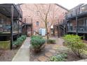 Cozy outdoor courtyard with stone pavers, lush greenery, and wrought-iron balconies for a tranquil setting at 3091 Colonial Way # D4, Atlanta, GA 30341