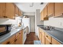 Functional kitchen features light wood cabinets, gray countertops, and essential appliances at 3091 Colonial Way # D4, Atlanta, GA 30341