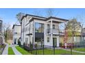 Side view of modern two-story home with black trim, large windows, balcony, fenced yard, and green lawn at 1137 Hardee Ne St # A, Atlanta, GA 30316