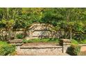 Stone entrance sign for Wildwood community surrounded by lush landscaping at 13212 Tolstoy, Covington, GA 30014