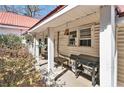 Cozy covered porch with seating, grill, and classic columns, perfect for outdoor entertaining at 204 Emory St, Oxford, GA 30054