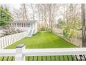 A spacious, well-manicured backyard with lush, green artificial turf, great for outdoor activities at 1195 Cameron Ne Ct, Atlanta, GA 30306