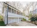 Charming home featuring a screened porch, white trim, and a convenient drive-under garage at 1195 Cameron Ne Ct, Atlanta, GA 30306