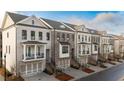 An aerial view of the luxury townhome community featuring brick exteriors, balconies, and well-manicured landscaping at 275 Briscoe Way # 3, Alpharetta, GA 30009