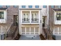 Brick townhome featuring front-entry garages, balcony, and iron railings in a quiet community at 275 Briscoe Way # 3, Alpharetta, GA 30009