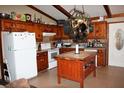 Rustic kitchen with wooden cabinets, a center island, and modern appliances at 7240 Colony Ln, Douglasville, GA 30135