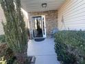 Inviting front porch with stone siding, a decorative light fixture, and ample seating space at 7248 Mountain Laurel Way, Stockbridge, GA 30281