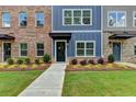 Townhome's charming exterior boasts colorful facades, fresh lawns, and welcoming sidewalks at 5473 Blossomwood Sw Trl, Mableton, GA 30126