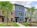 Beautiful townhome exteriors feature colorful facades, manicured lawns, and inviting walkways at 5473 Blossomwood Sw Trl, Mableton, GA 30126