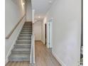 Welcoming entryway featuring hardwood floors, a staircase, and fresh, neutral paint at 5477 Blossomwood Sw Trl, Mableton, GA 30126