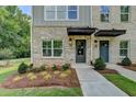 Inviting entrance of a townhome with well-maintained landscaping and a welcoming front door at 5497 Blossomwood Sw Trl, Mableton, GA 30126