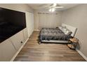 Relaxing bedroom with a modern bed frame, gray luxury vinyl plank flooring, and a ceiling fan at 475 Lakeside Cir, Covington, GA 30016