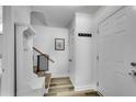 Bright entryway featuring coat rack, staircase and light wood flooring at 5 Spring Green Pl, Atlanta, GA 30318