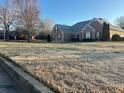 Brick home with well-maintained lawn, bare trees on a large lot at 1507 Smithfield Dr, Mcdonough, GA 30252