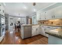 Modern kitchen featuring granite countertops, stainless steel appliances, and hardwood floors at 4323 Lake Chimney Ne Ct, Roswell, GA 30075