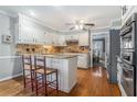 Updated kitchen featuring tile backsplash, granite countertops, and stainless steel appliances at 4323 Lake Chimney Ne Ct, Roswell, GA 30075