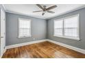 Bright bedroom with hardwood floors, neutral walls, and natural light from two windows at 1472 Norman Berry Dr, Atlanta, GA 30344