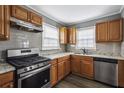 Updated kitchen features stainless steel appliances, wood cabinets and sleek countertops at 1472 Norman Berry Dr, Atlanta, GA 30344