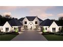 Elegant exterior view of a two-story home showcasing its symmetrical design, stone entrance, and lush landscaping at 4428 Blackland Dr, Marietta, GA 30067