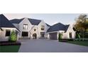 Charming two-story home featuring a stone arch entry, black trim windows, and a spacious three-car garage at 4428 Blackland Dr, Marietta, GA 30067