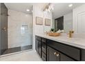 Modern bathroom featuring a double vanity, sleek fixtures, and a glass-enclosed shower with tile surround at 1903 Deco Dr, Kennesaw, GA 30144