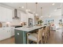 Open-concept kitchen with a large island and bar chairs, perfect for entertaining and casual dining at 1903 Deco Dr, Kennesaw, GA 30144