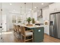 Bright kitchen featuring a large island with bar seating, stainless steel appliances, and pendant lighting at 1903 Deco Dr, Kennesaw, GA 30144