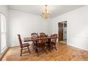 Formal dining room with hardwood floors and a classic chandelier, perfect for Gathering meals at 211 Congress Pkwy, Lawrenceville, GA 30044