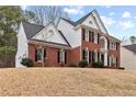 Side view of a brick two-story home with black shutters showcasing a well-maintained exterior at 211 Congress Pkwy, Lawrenceville, GA 30044