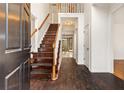 Inviting foyer featuring hardwood floors, a staircase, and a bright, open entrance at 211 Congress Pkwy, Lawrenceville, GA 30044