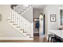 Bright entryway featuring a staircase with decorative railings and arched doorway adding architectural interest at 10594 Serenbe Ln, Chattahoochee Hills, GA 30268