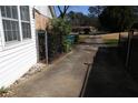 Long concrete driveway with metal gate and side access to the home at 575 Midland Park Dr, Stone Mountain, GA 30087