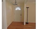Bright entryway featuring hardwood floors and a classic chandelier at 575 Midland Park Dr, Stone Mountain, GA 30087