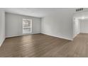 A bright living room featuring wood floors, a window with diamond pattern, and neutral paint at 3183 Abbeywood Dr, Decatur, GA 30034