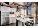 Modern kitchen features stainless steel appliances and an island with breakfast bar seating at 5434 Peachtree Rd # 115, Chamblee, GA 30341