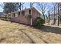 Side view of brick home showcasing the manicured lawn and classic architecture at 5468 Melanie Sw Ln, Mableton, GA 30126