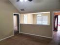 Cozy living room featuring neutral walls, carpet flooring and a partial view of the adjacent room at 130 Willow Shoals Dr, Covington, GA 30016