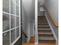 Inviting entryway with a staircase, wooden floors, grey walls, and natural light streaming through the front door at 132 Wetherbrooke Ln # 3, Smyrna, GA 30082