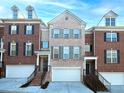 Well-maintained townhome exteriors with brick, garages, complementary shutters, and inviting curb appeal at 132 Wetherbrooke Ln # 3, Smyrna, GA 30082